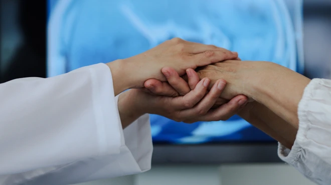 Doctor holding patients hand