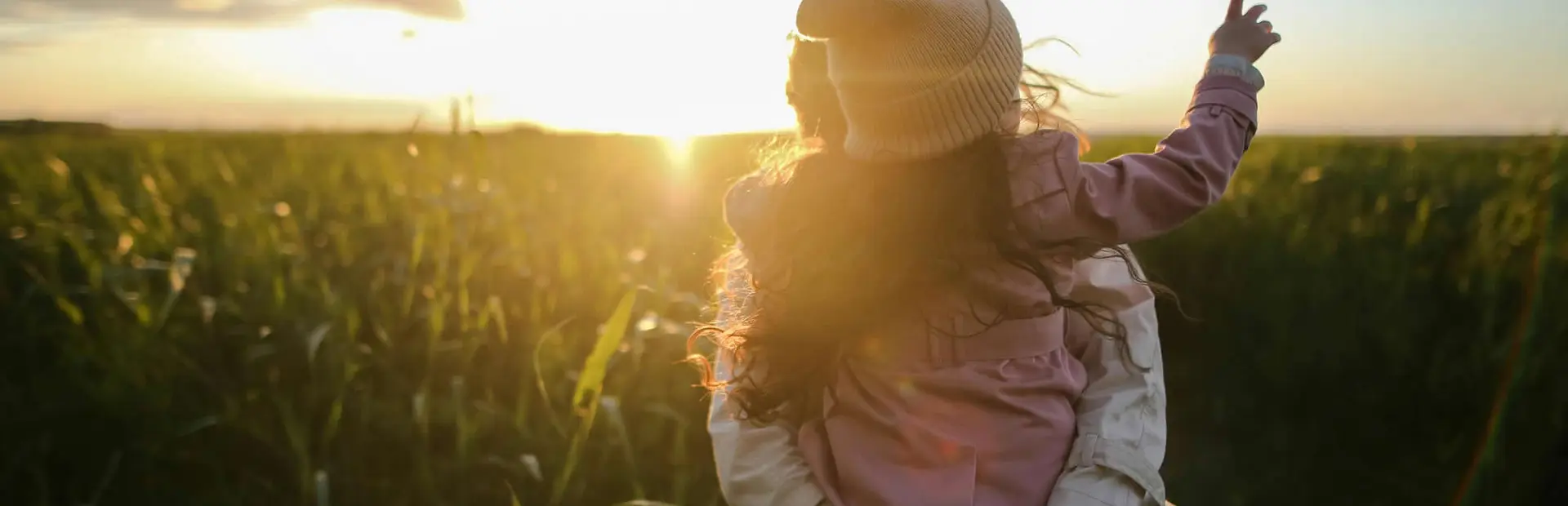 Woman with child outdoors in open field