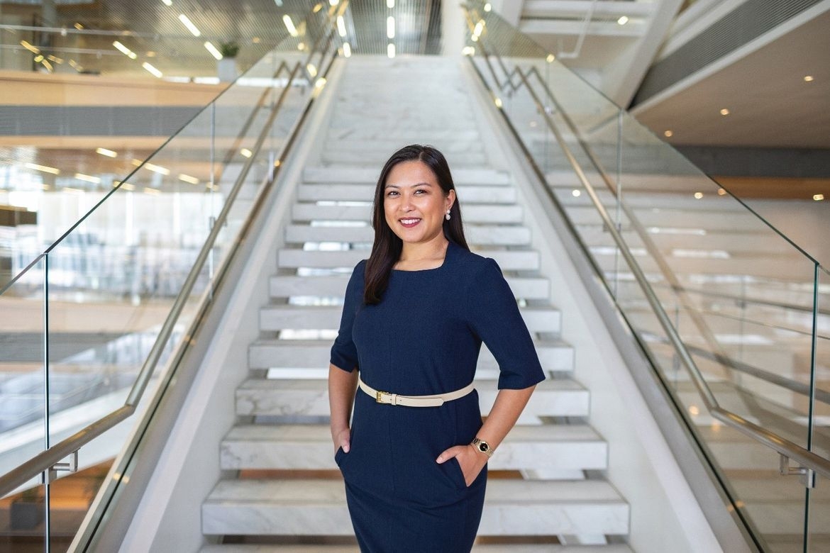 Woman posing by the stairs
