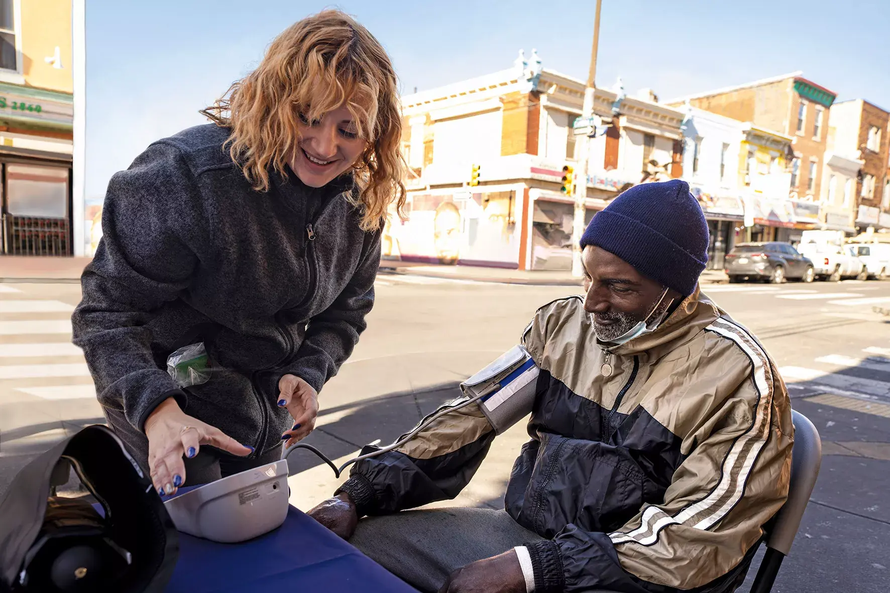 maggie perez checks blood pressure local resident.jpg