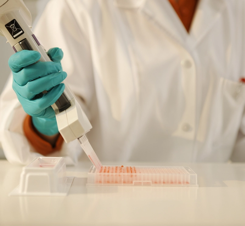 Laboratory technician conducting a test with a pipette