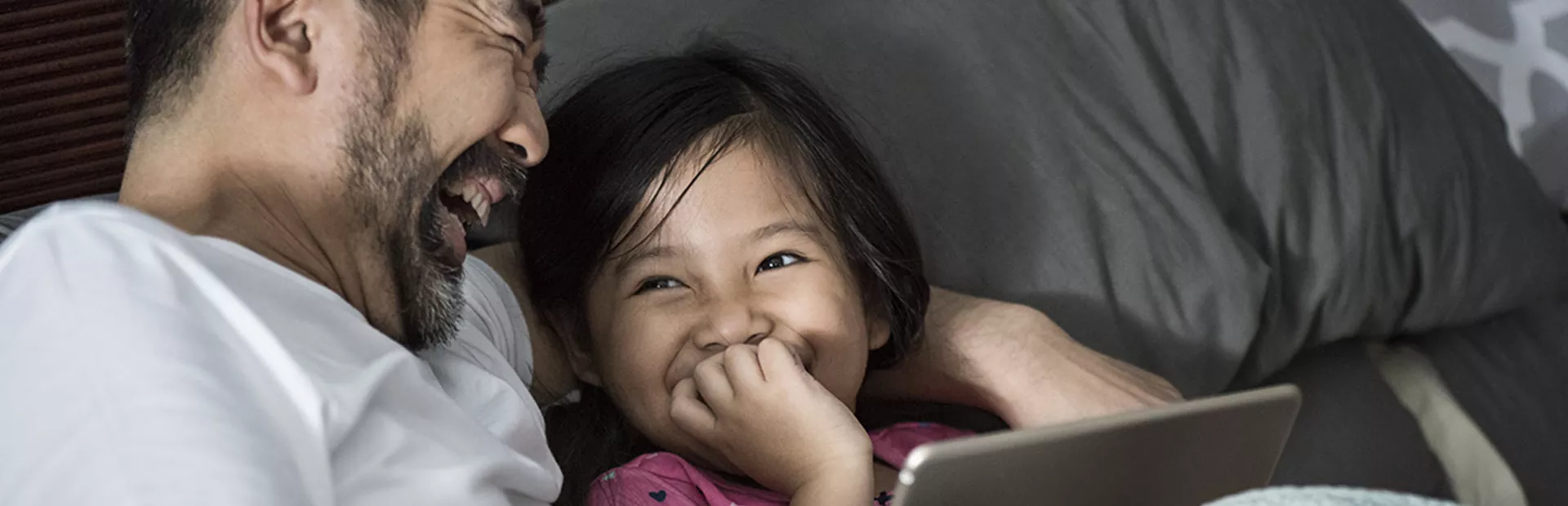 A father and daughter laughing