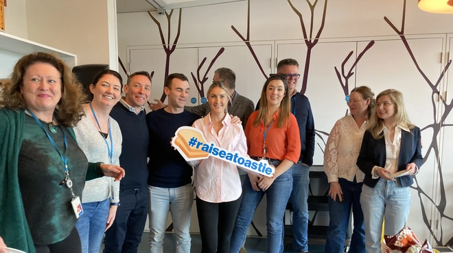 Image of Novartis staff raising a toastie to support rare disease day Image of Novartis staff raising a toastie to support rare disease day