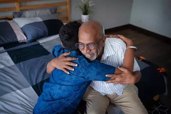 Grandfather and grandson hugging