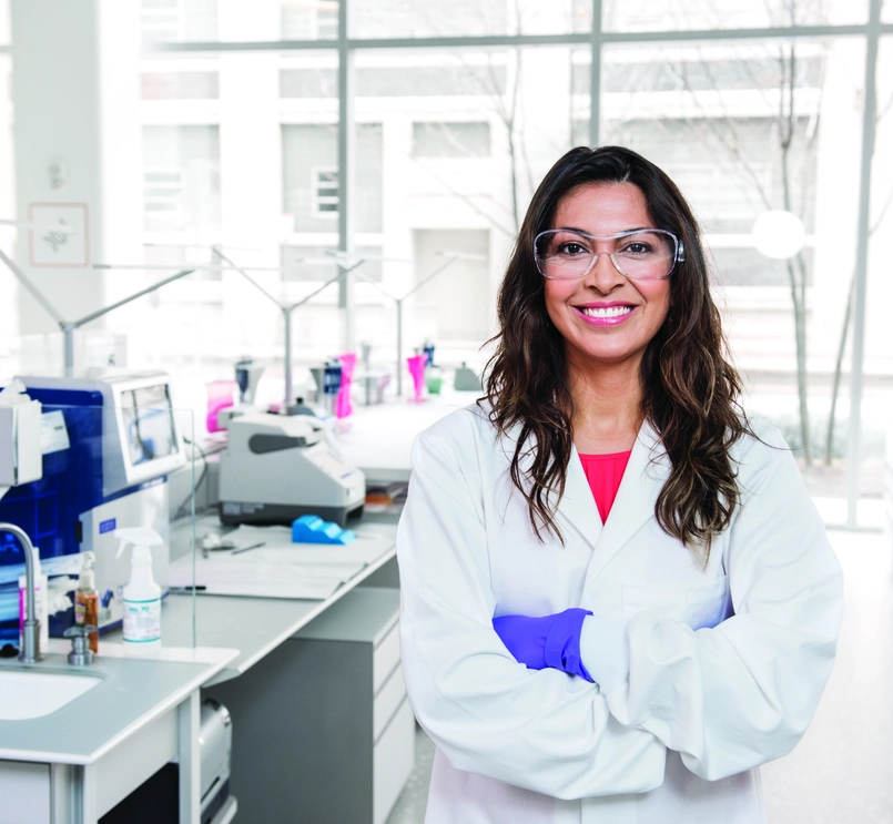 A happy scientist with goggles in the lab