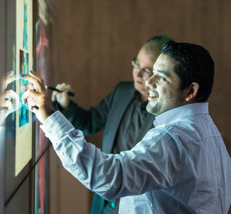 People working on touchscreen