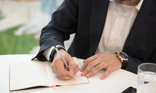 Men writing on Notebook