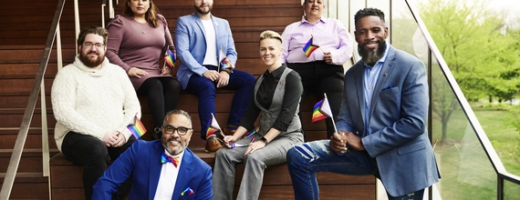 Un gruppo di persone è seduto su delle scalinate per scattare una foto