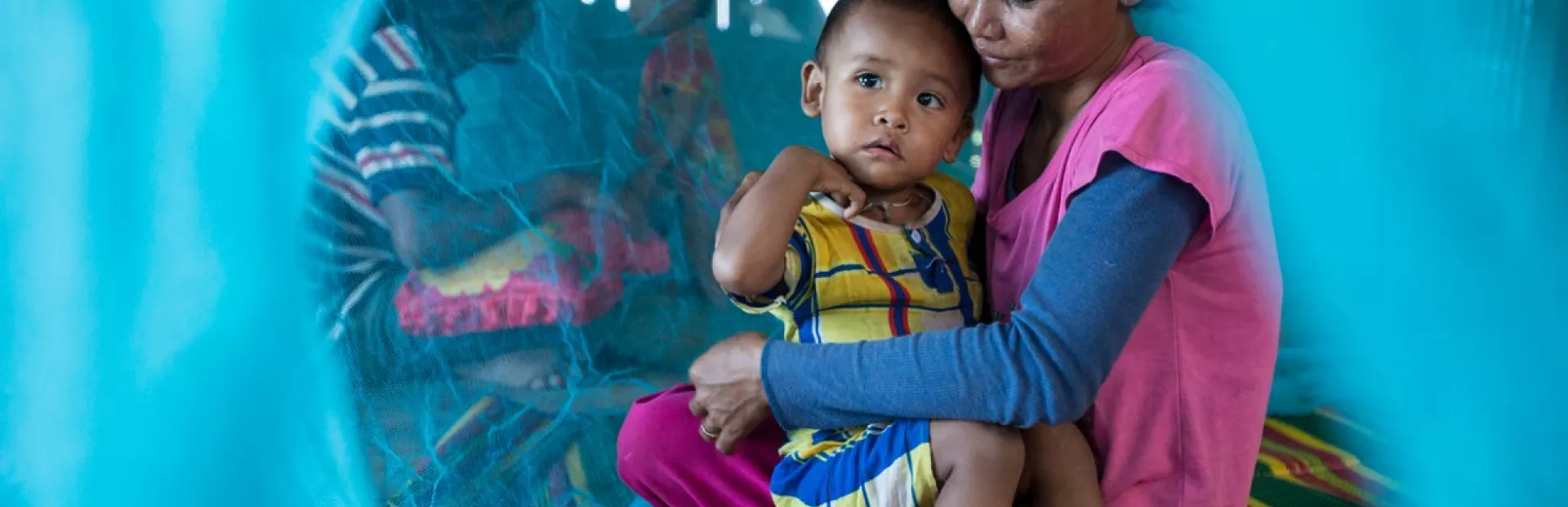 mother child insecticide treated net image