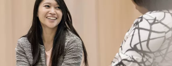 Woman smiling and talking with a colleague