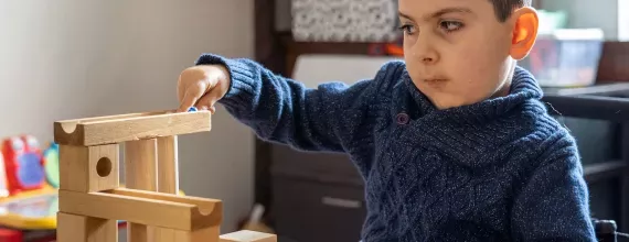 boy-playing-wooden-marble-runs-toy