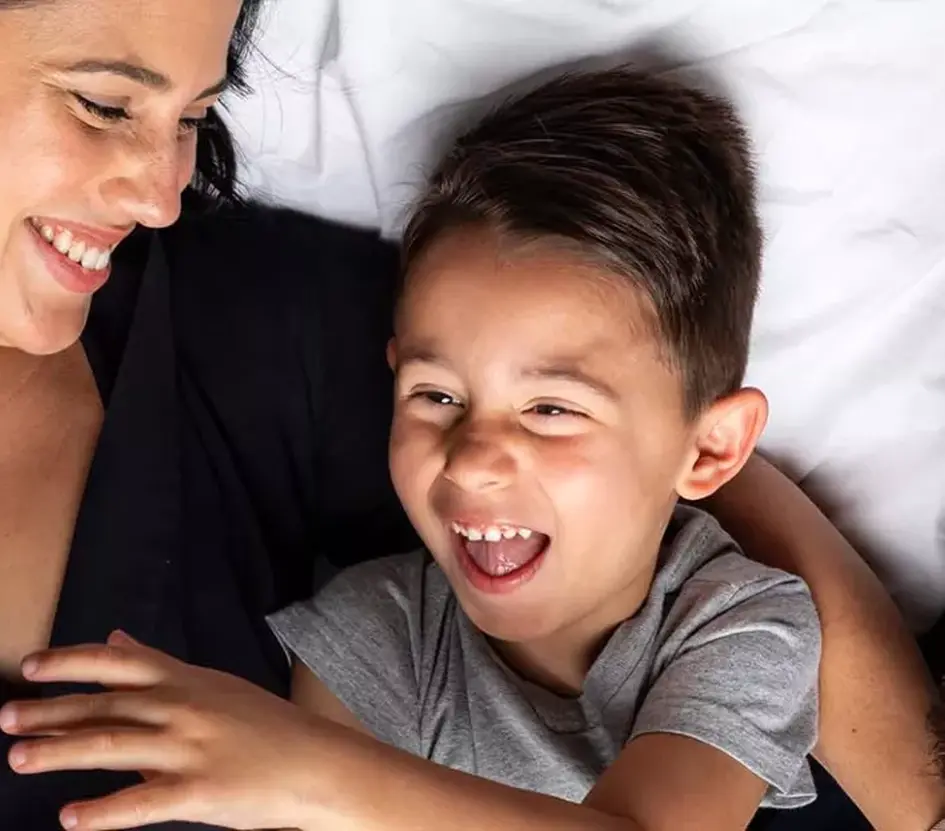 parents-snuggling-with-son-sma