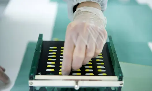 A hand with a pill tray