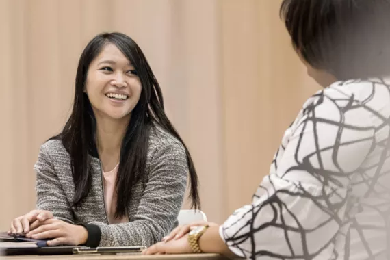 Woman smiling and talking with a colleague