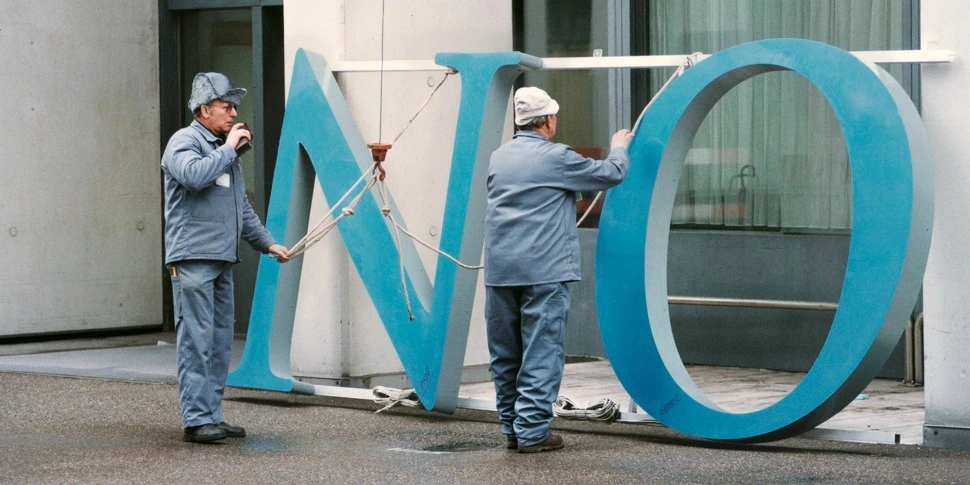 In 1996, the merger of Sandoz and Ciba-Geigy creates Novartis, one of the world's largest healthcare companies. This image, taken on February 3, 1997, shows the old logo being changed out at the Novartis St. Johann site in Basel.