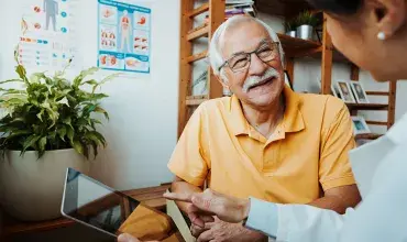 hcp-discussing-with-smilling-senior-patient-card.jpg