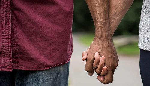 Two people holding hands