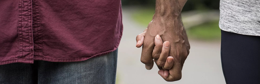 Two people holding hands
