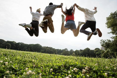 Group of young adults jumping