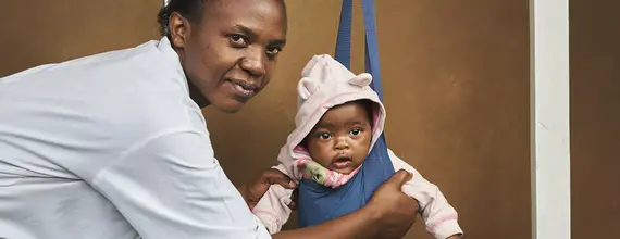 A health worker playing with a toddler
