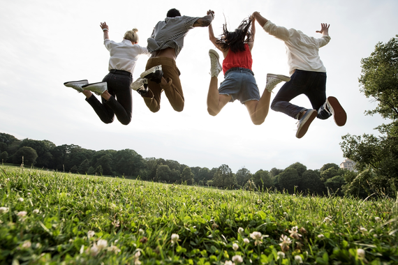 Group of young adults jumping