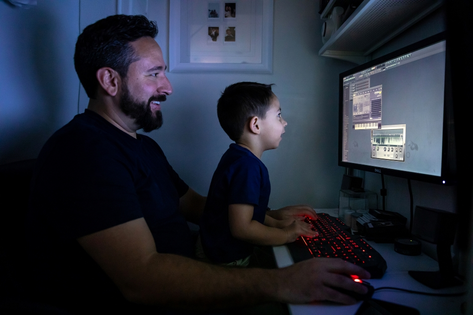 Father and son playing on computer