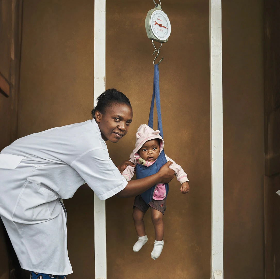 A health worker playing with a toddler