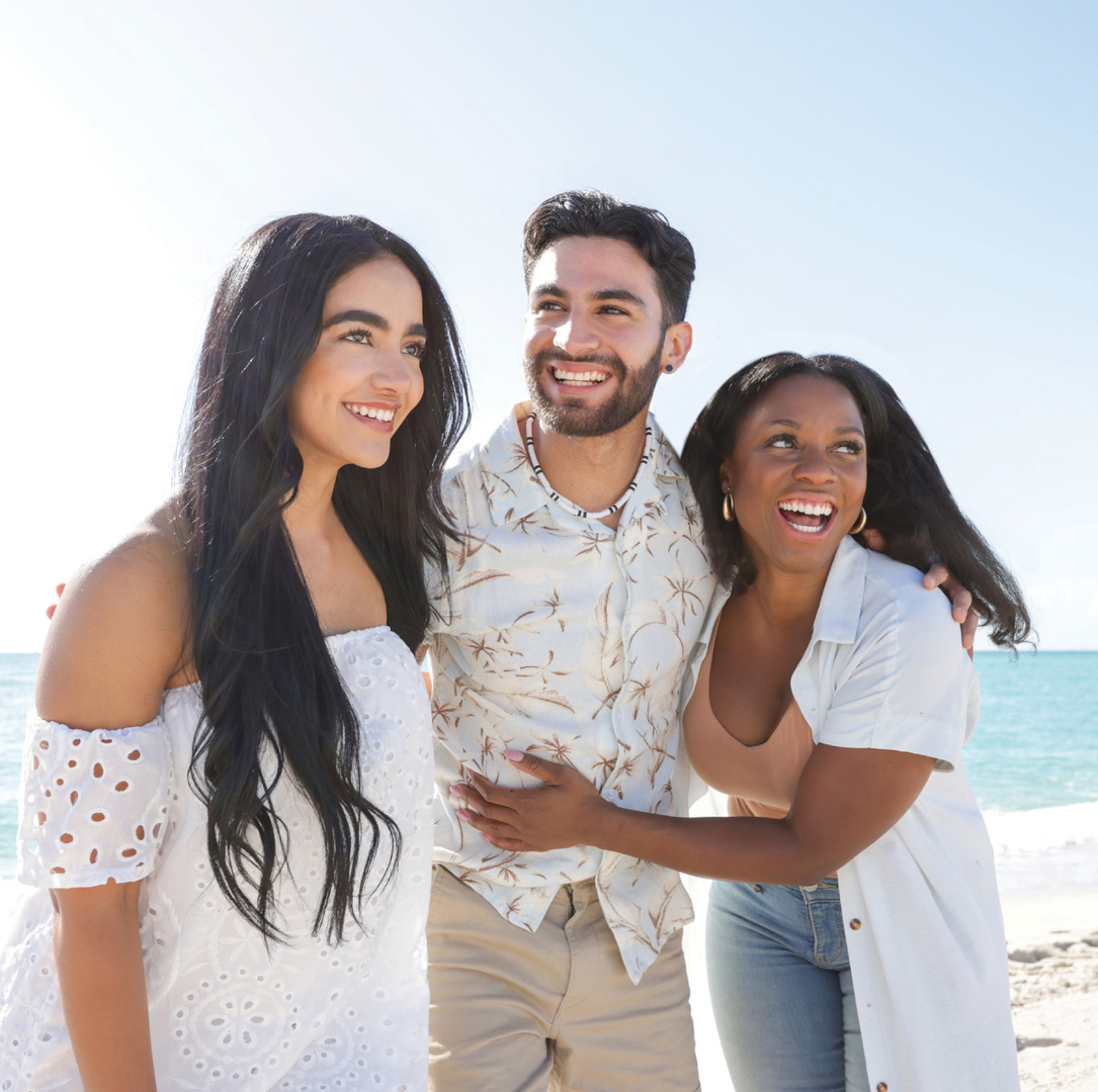 A group of friends hang out at the beach on a sunny day