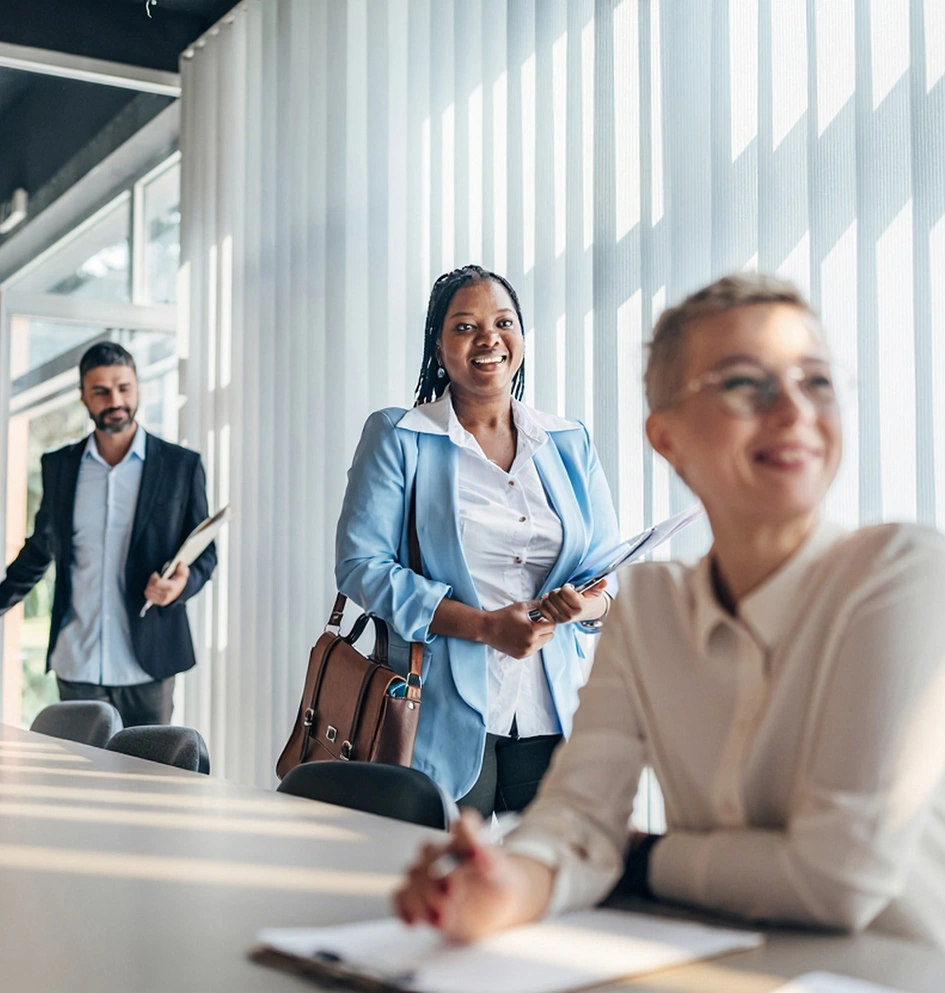 Three business people in a modern and bright meeting room