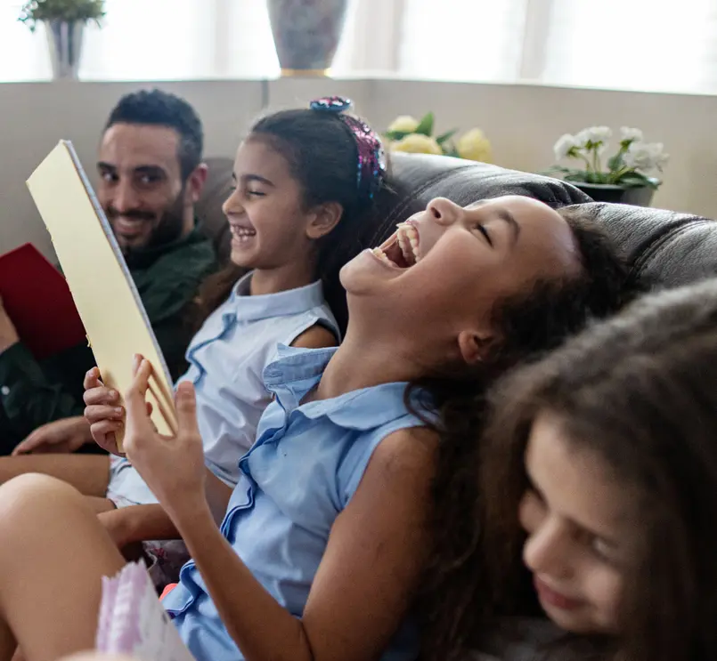 People laughing together on a sofa