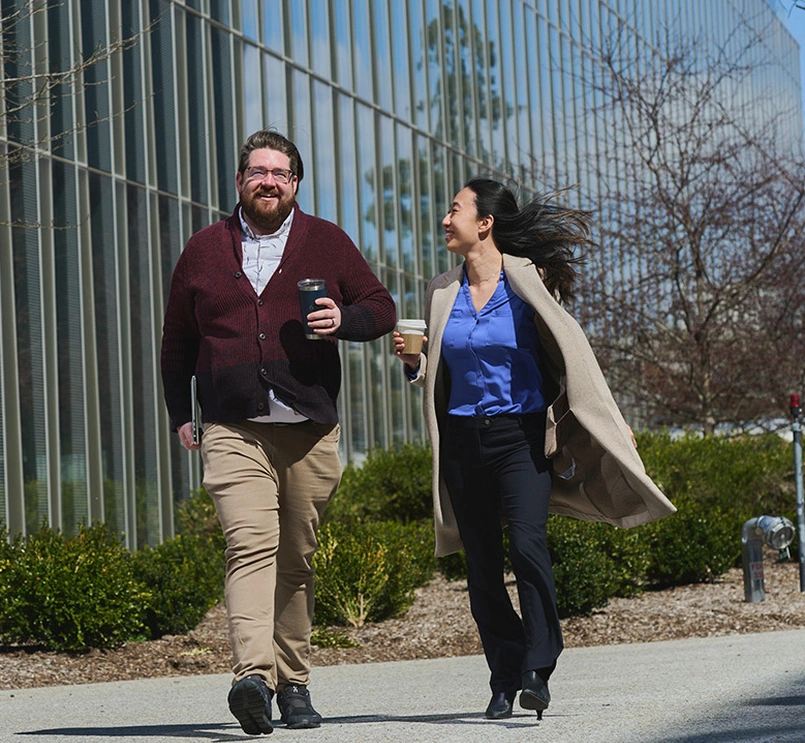 Two business people walking and casually chatting