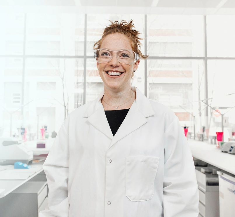 Scientist wearing glasses smiling at the camera