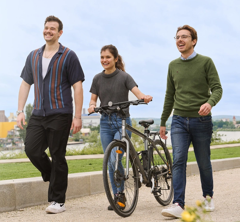 Three young people walking in a park