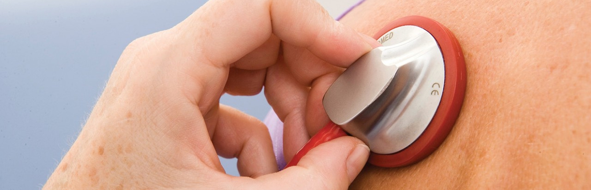 Doctor listening to patient’s lungs with stethoscope