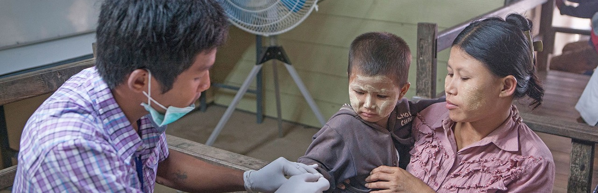 Young child next to his mother getting examine