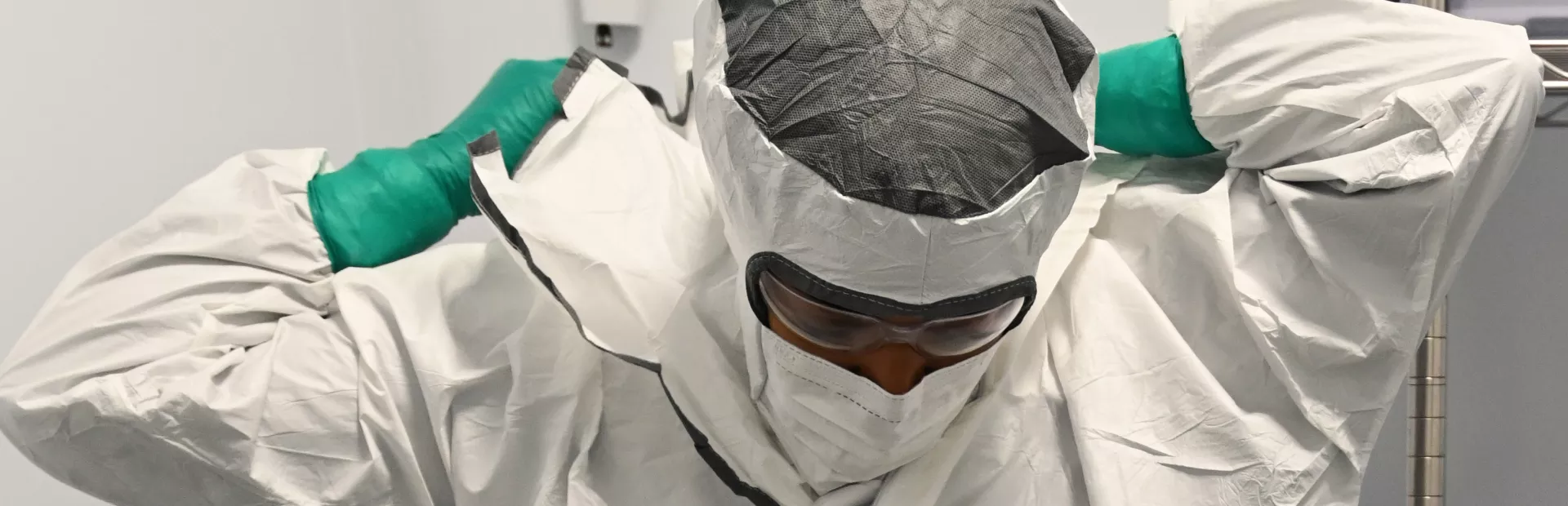 A highly trained Novartis specialist dresses in full personal protective equipment to work on the radioligand therapy production line