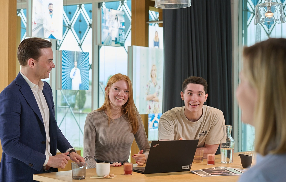 Early careers professionals smile at camera