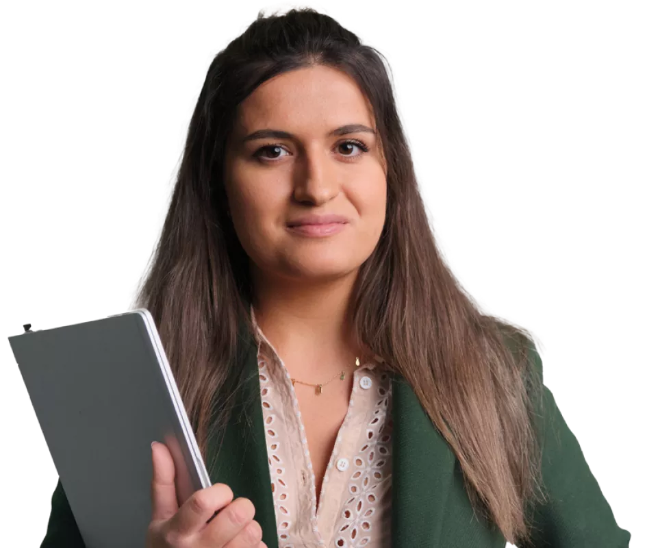 A portrait of a female Novartis associate holding a laptop
