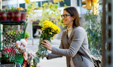 Woman buying yellow flowers