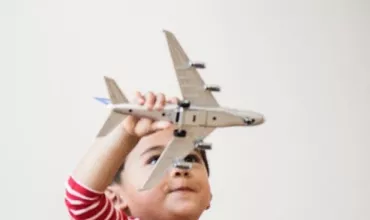 A boy flying a model of an aeroplane