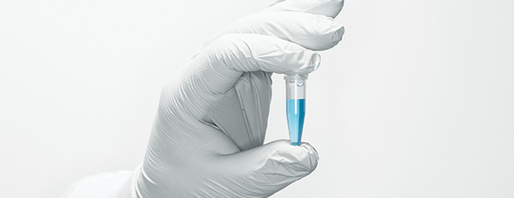 Hand with white glove holding a sample