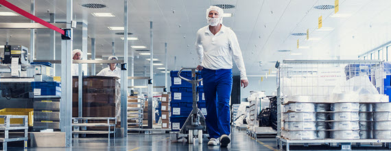 A Novartis technician walking in a manufacturing plant