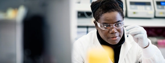 Research scientist in a lab looking at a sample