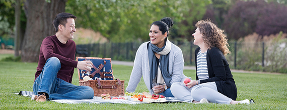 A smiling group of friends in a park.