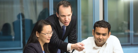 A group of three business professionals in meeting