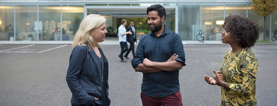 Three colleagues talking outside Fabrikstrasse