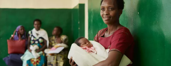 mother waiting with infant in clinic africa