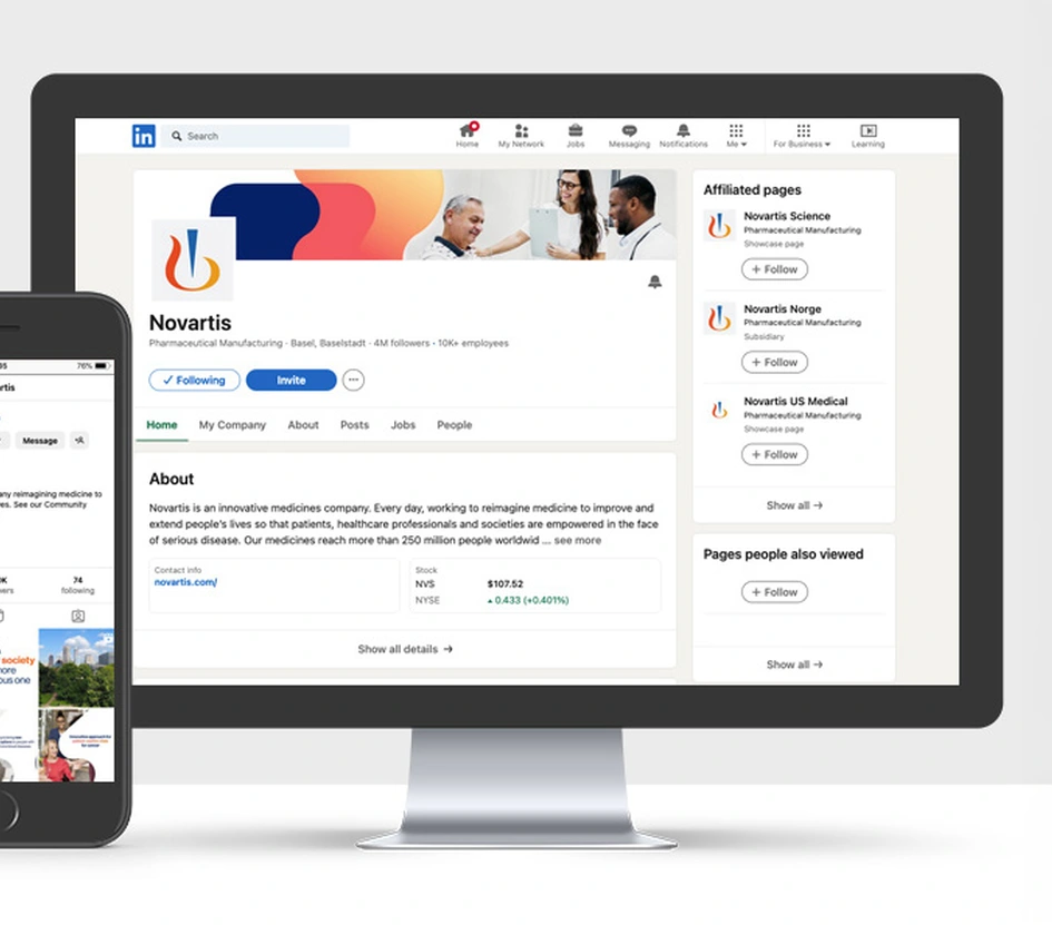 View of a desk with a phone and a monitor on it containing Novartis social media accounts