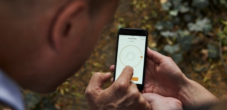 Individual interacts with digital technology via mobile phone