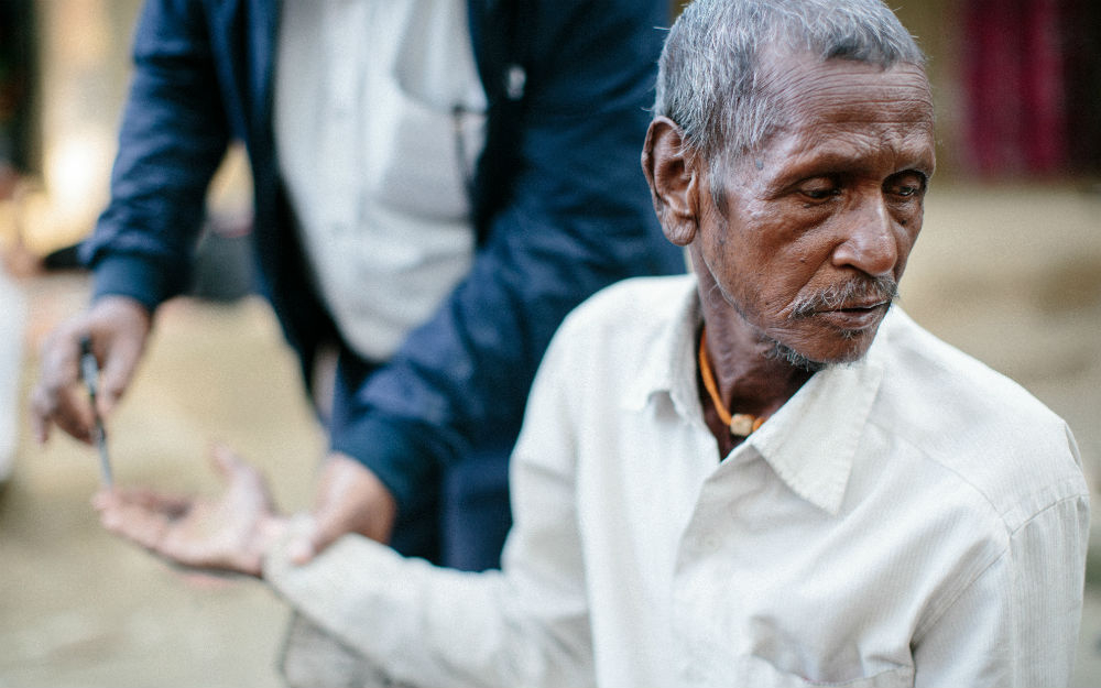 Man being tested for leprosy with pen